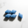 Super Kamagra blue tablets on white marble — sildenafil and dapoxetine for ED and PE